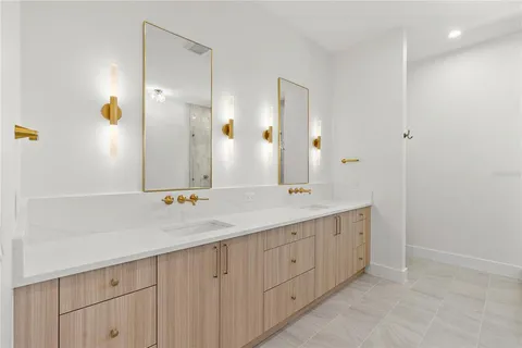 a bathroom with a double vanity sink and a mirror