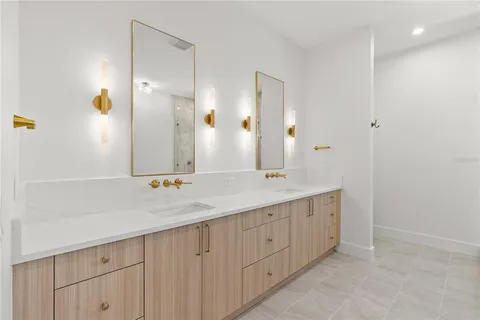 a bathroom with a double vanity sink and a mirror