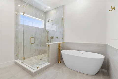 a bathroom with a bathtub and shower