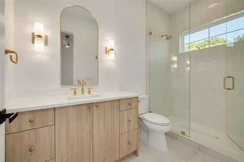 an aerial view of a house with a yard and wooden fence