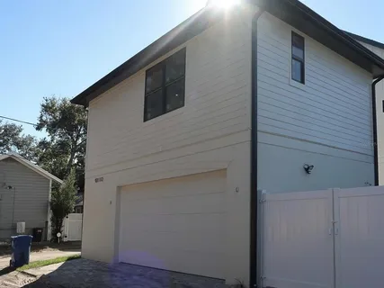 a view of a house with backyard space and wooden floor