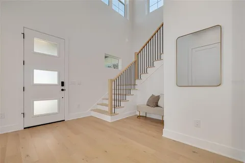 a kitchen with stainless steel appliances a stove a sink a refrigerator a center island a dining table and chairs