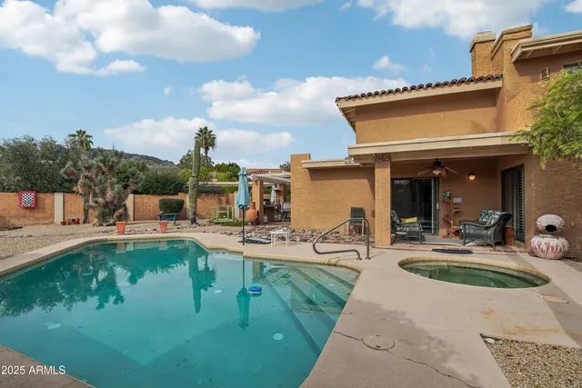 a view of a patio with swimming pool table and chairs