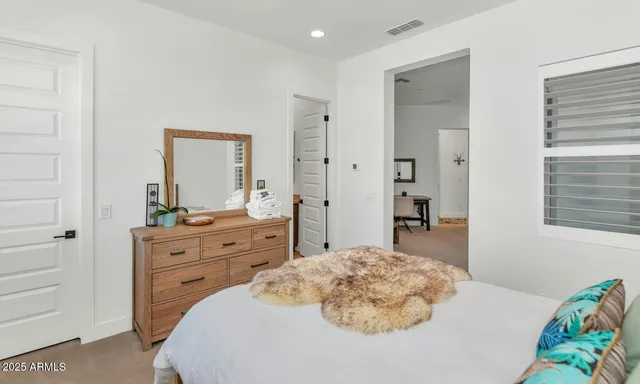 a bedroom with a bed and a dresser