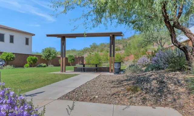 a view of a house with backyard and a sitting area
