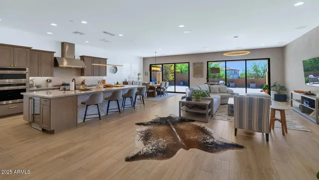a living room with lots of furniture and kitchen view