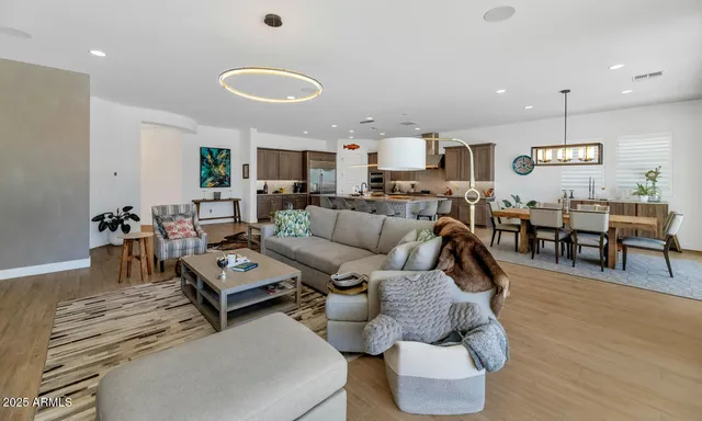 a living room with lots of furniture and wooden floor