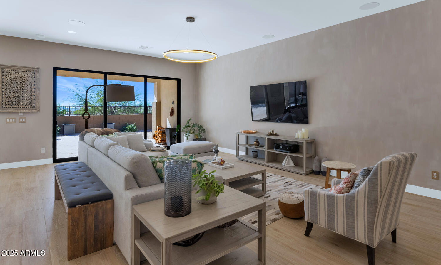 2041 East Fallen Leaf Lane Phoenix, AZ 85024 - Photo 6 of 31 a living room with furniture a flat screen tv and a floor to ceiling window