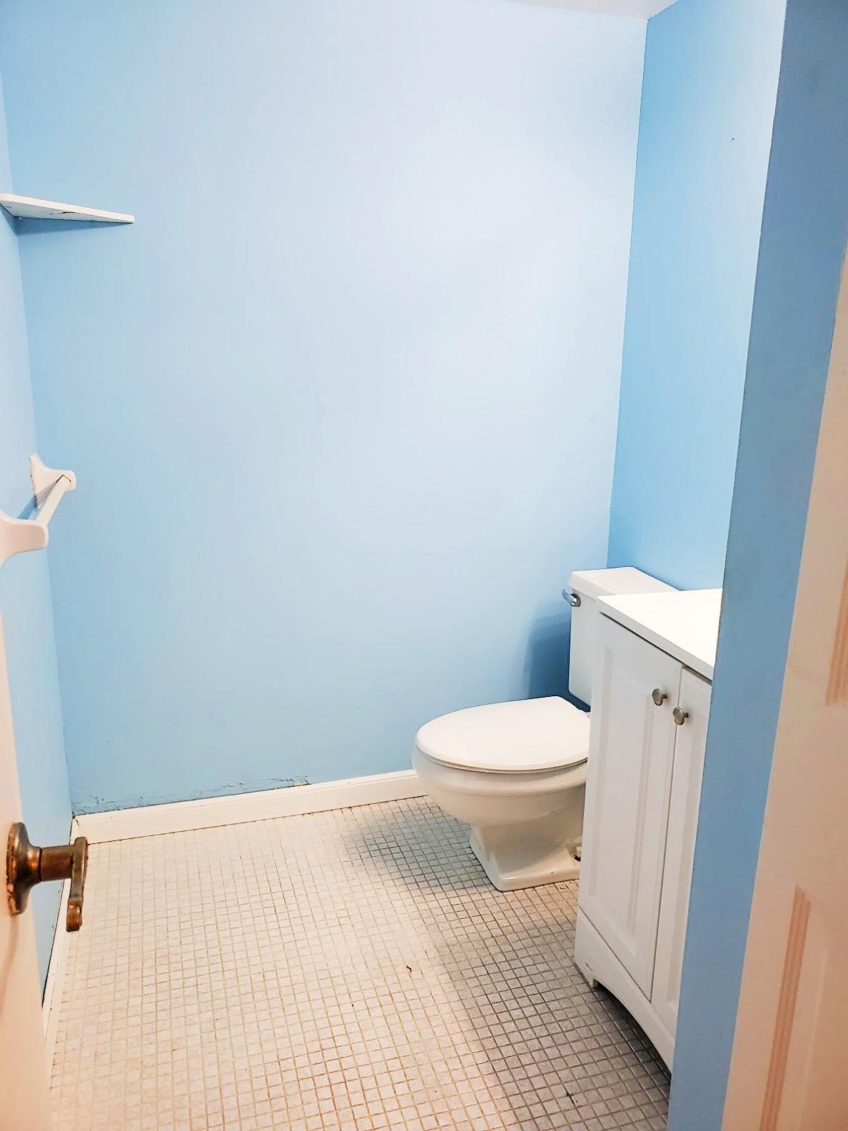 4156 Inverrary Drive, Unit 305 Lauderhill, FL 33319 - Photo 9 of 13 a white toilet sitting next to a white cabinet