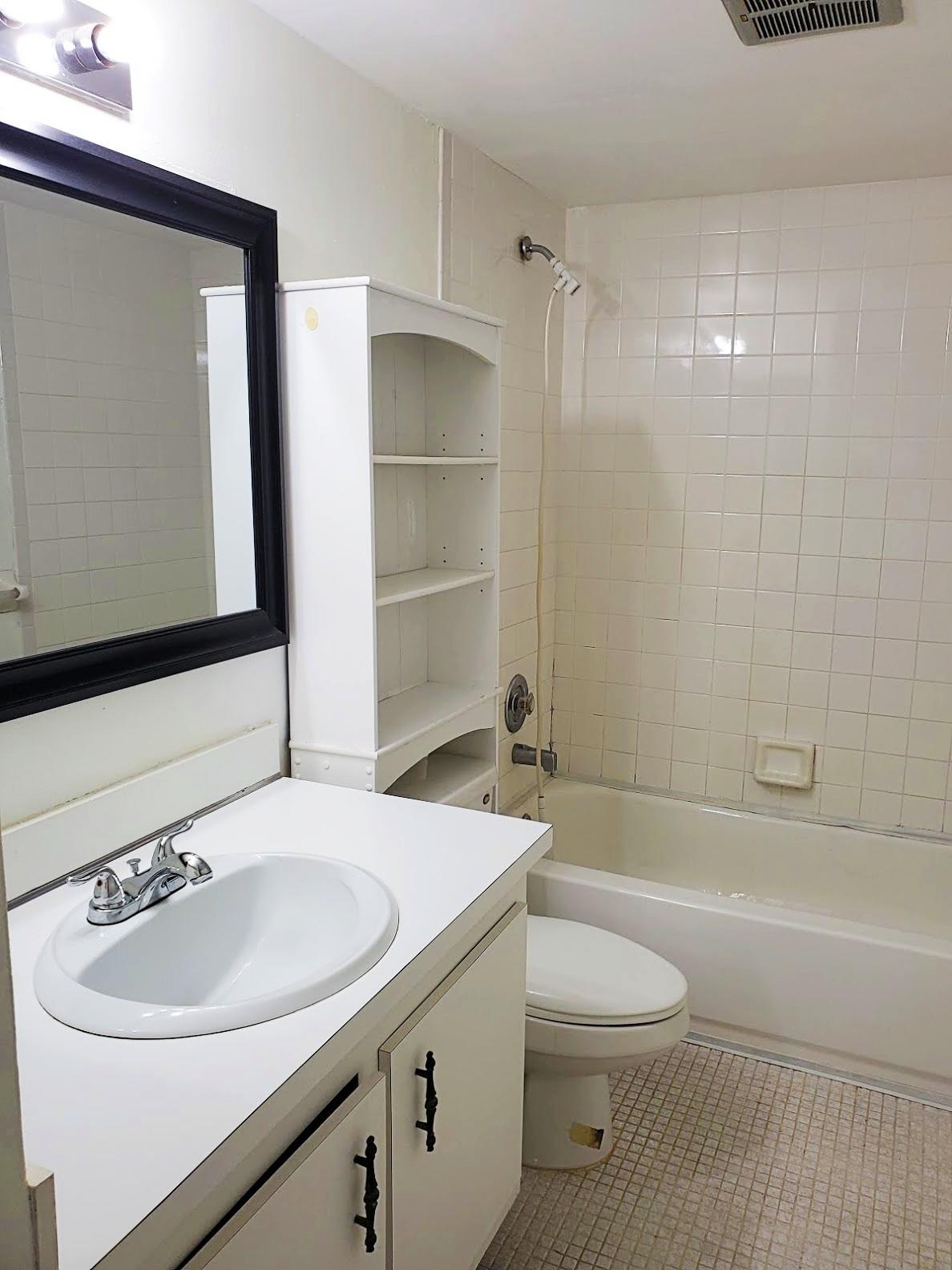 4156 Inverrary Drive, Unit 305 Lauderhill, FL 33319 - Photo 10 of 13 a bathroom with a sink a toilet and shower