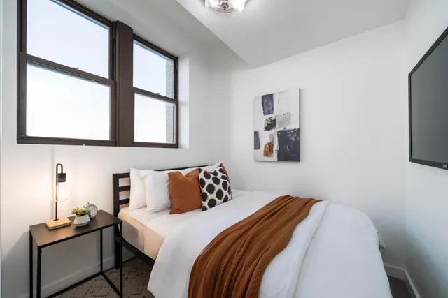 a bedroom with a bed and a window