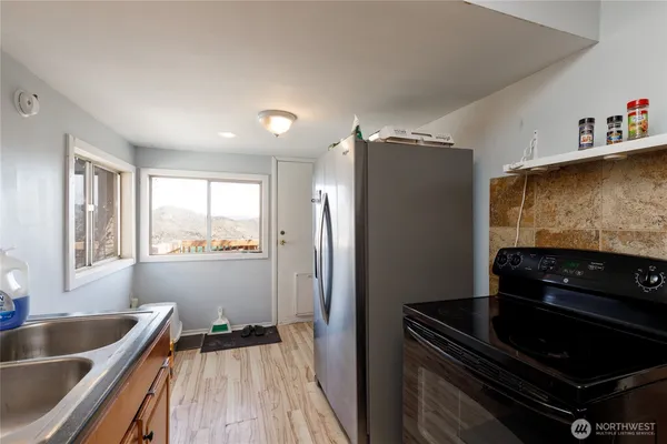 a kitchen with granite countertop a refrigerator and a sink