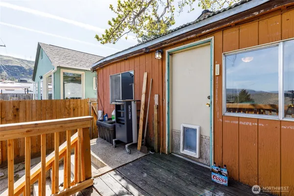 a view of a porch with wooden floor and furniture