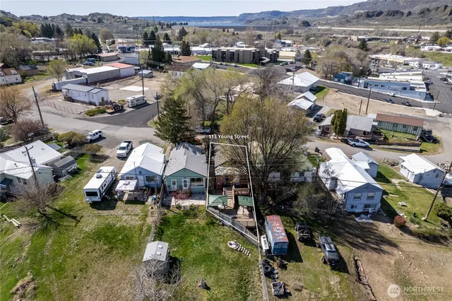 an aerial view of house with yard swimming pool and outdoor seating