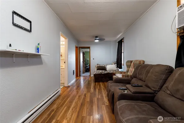 a living room with furniture and a wooden floor