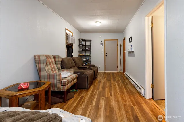 a living room with furniture and a wooden floor