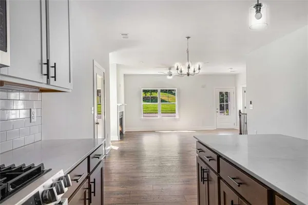 a kitchen with kitchen island a wooden floor and stove