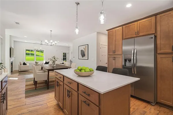 a kitchen with kitchen island a table and chairs