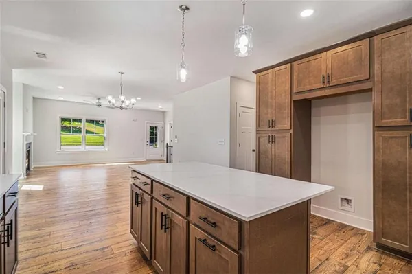 a kitchen with kitchen island white cabinets and stainless steel appliances