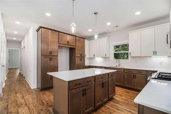 a kitchen with stainless steel appliances granite countertop refrigerator sink and cabinets