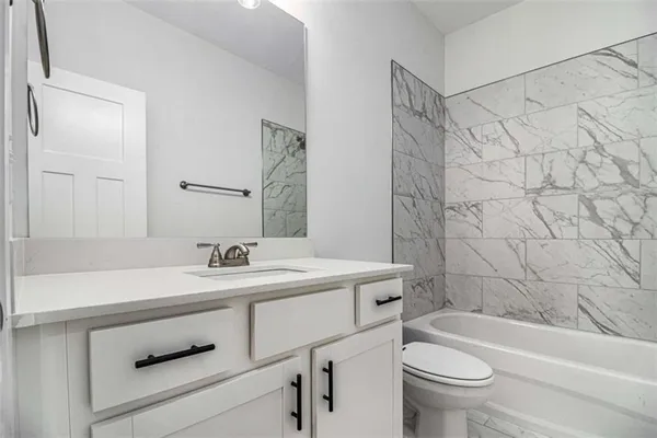 a bathroom with a sink a toilet and a bathtub