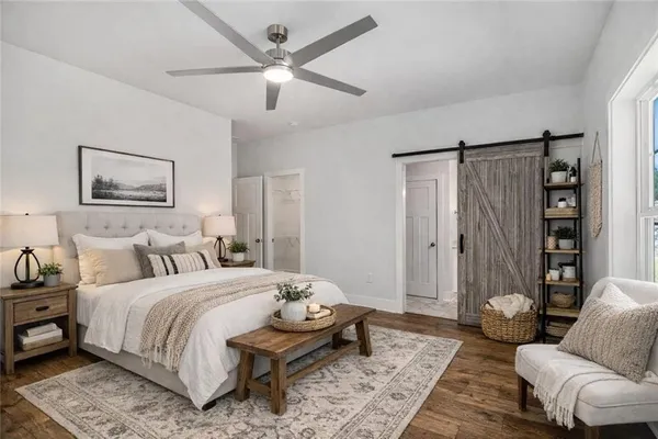 a bedroom with a bed couches and a chandelier