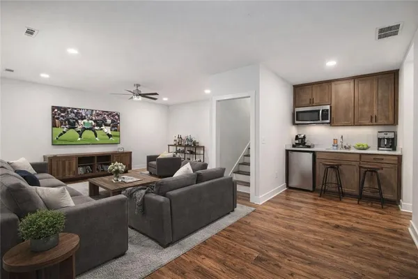 a living room with furniture and kitchen view
