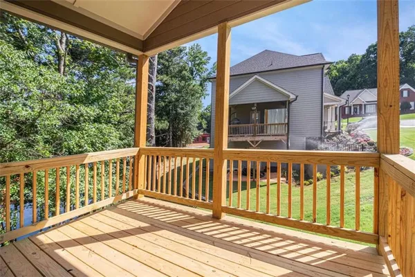a balcony view with wooden floor and fence