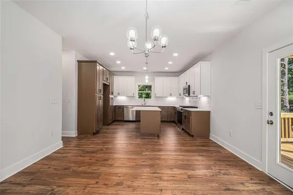 a view of a kitchen with a sink stainless steel appliances and cabinets