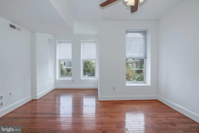 wooden floor in an empty room with a window