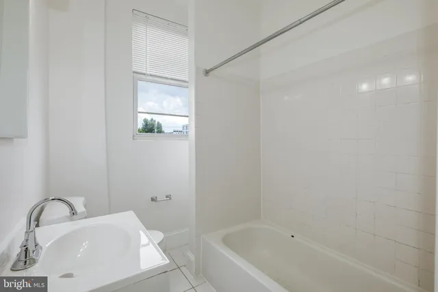 a bathroom with a tub sink and vanity