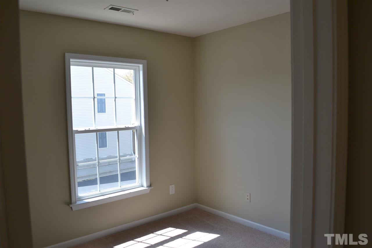 8107 Rhiannon Road Raleigh, NC 27613 - Photo 14 of 24 a view of an empty room with a window