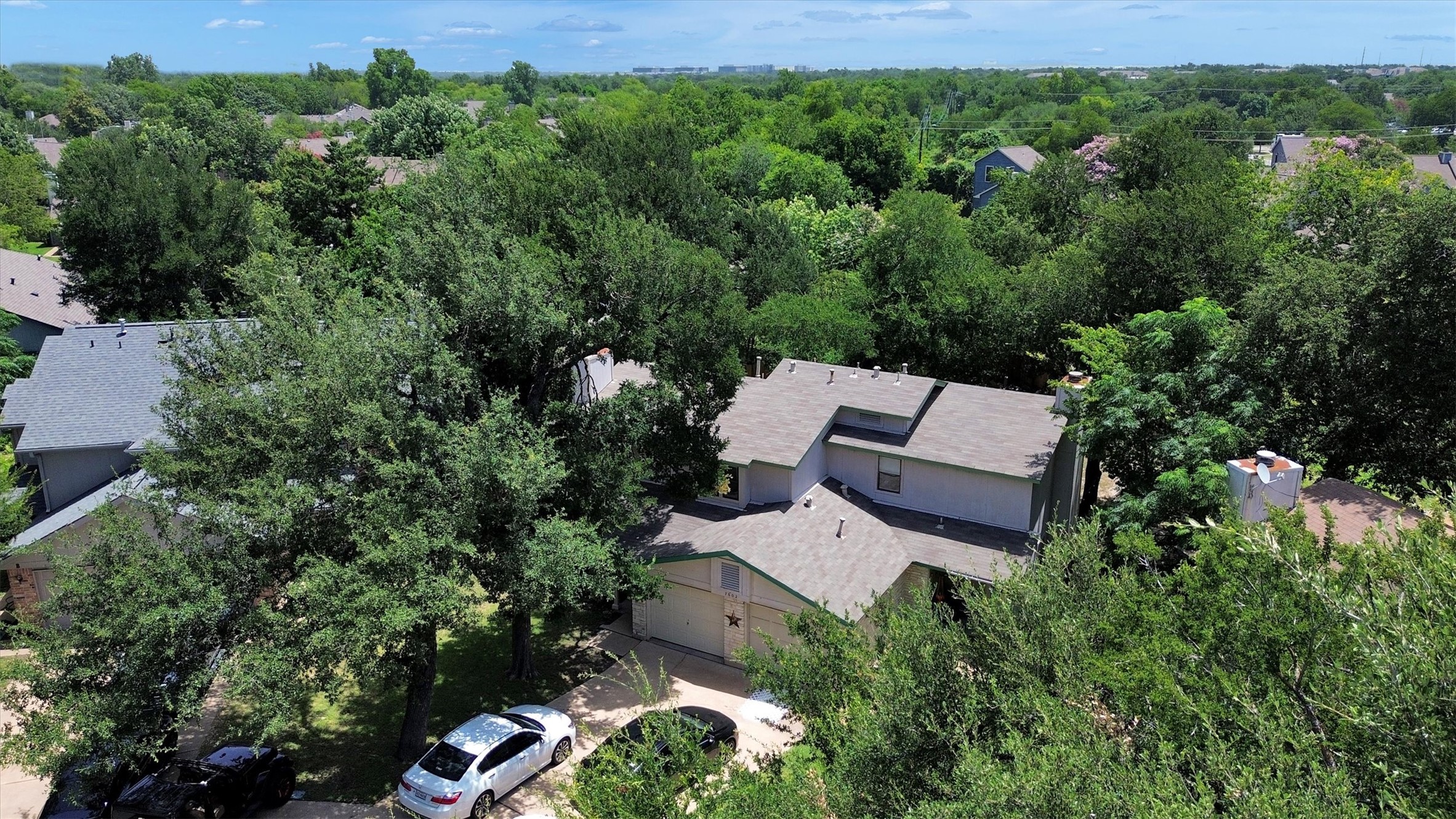 7802 Topawa Cove, Unit B Austin, TX 78729 - Photo 28 of 32 An aerial perspective reveals a private residence nestled amongst a verdant, tree-lined neighborhood.