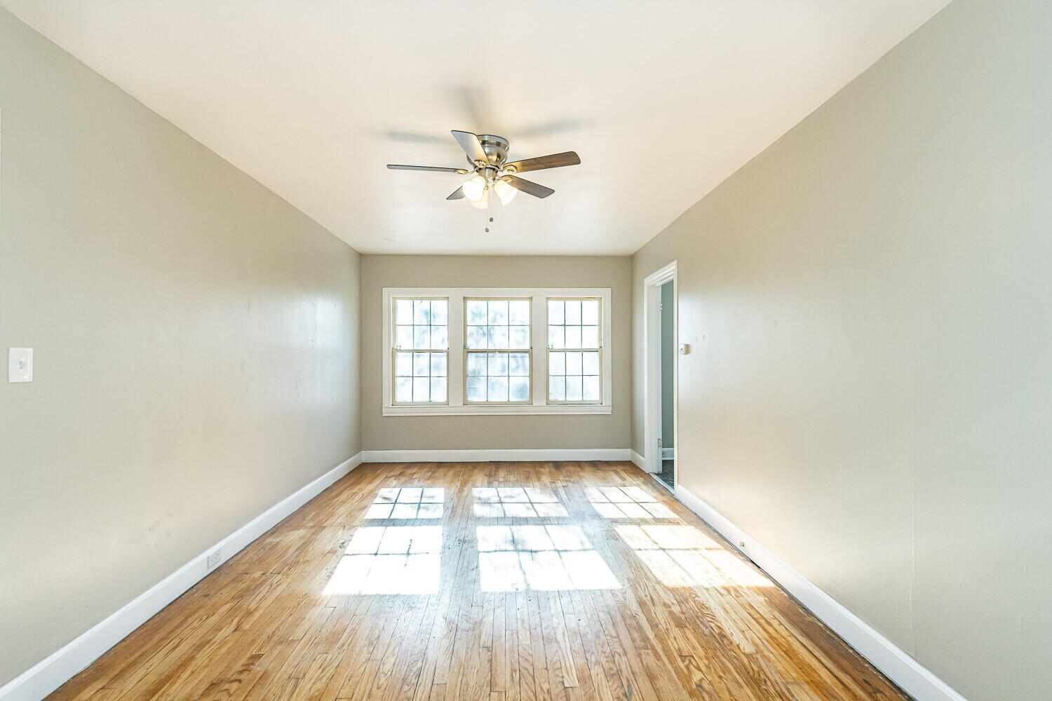 1914 25th Street Lubbock, TX 79411 - Photo 18 of 48 a view of empty room with wooden floor and fan