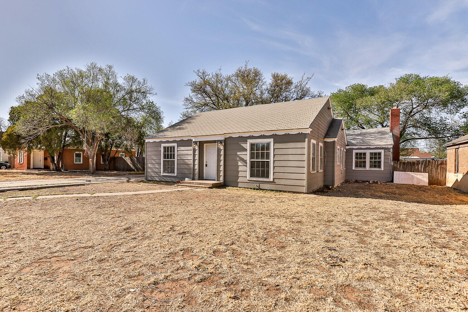 1914 25th Street Lubbock, TX 79411 - Photo 2 of 48 a front view of a house with a yard and garage