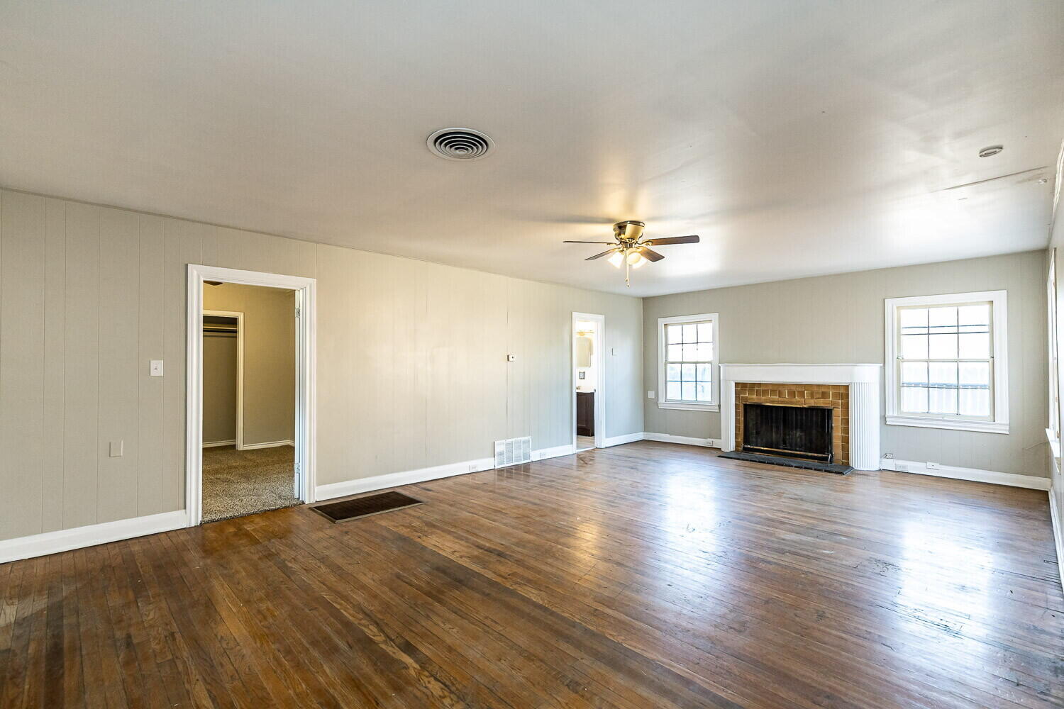 1914 25th Street Lubbock, TX 79411 - Photo 33 of 48 an empty room with wooden floor fireplace and chandelier fan