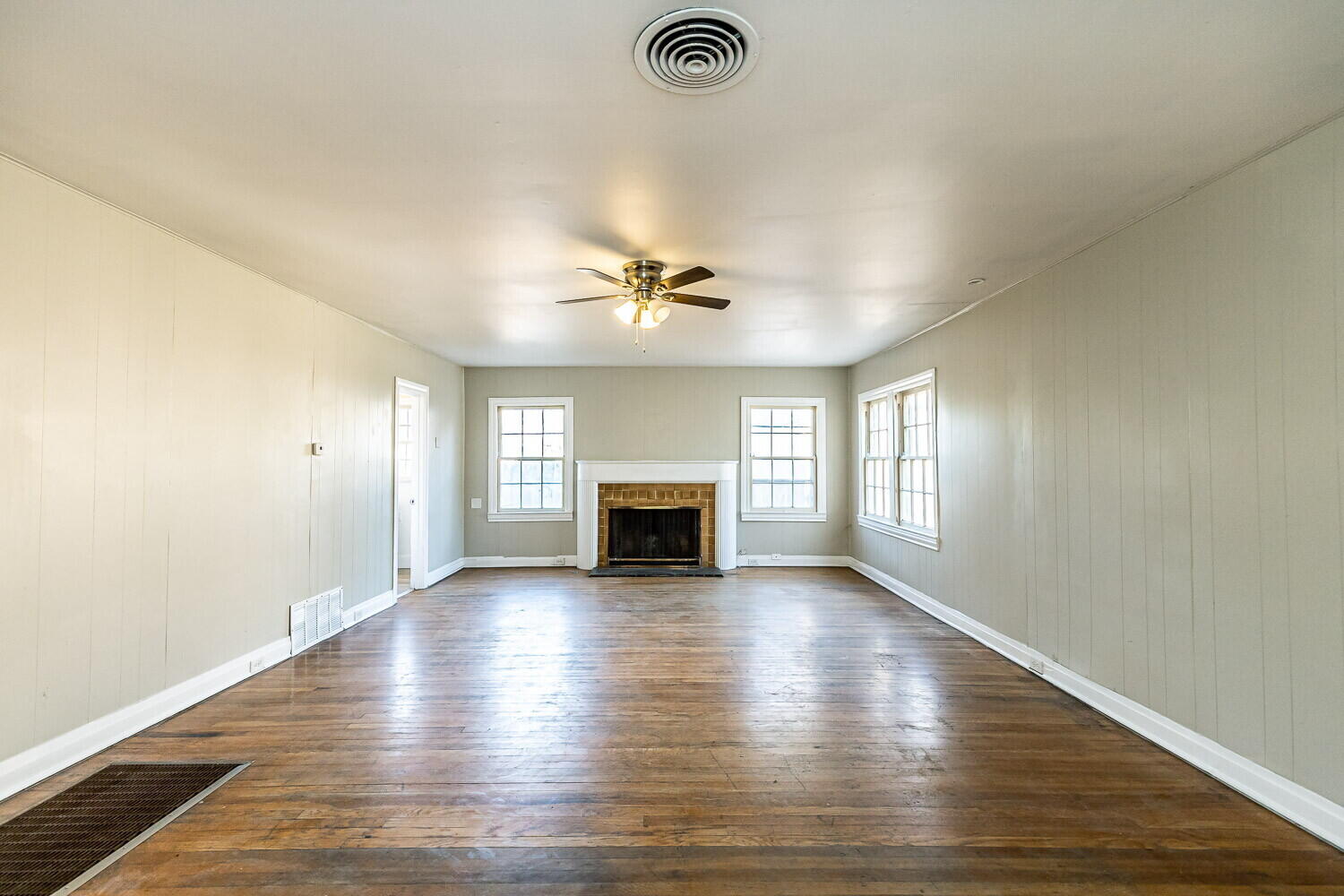 1914 25th Street Lubbock, TX 79411 - Photo 34 of 48 an empty room with wooden floor fireplace and windows