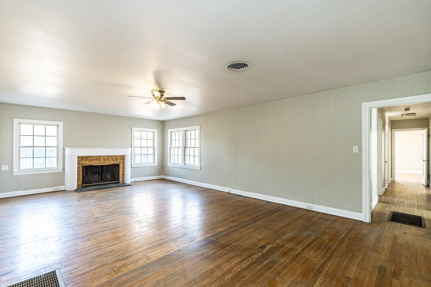 1914 25th Street Lubbock, TX 79411 - Photo 35 of 48 an empty room with wooden floor fireplace and windows