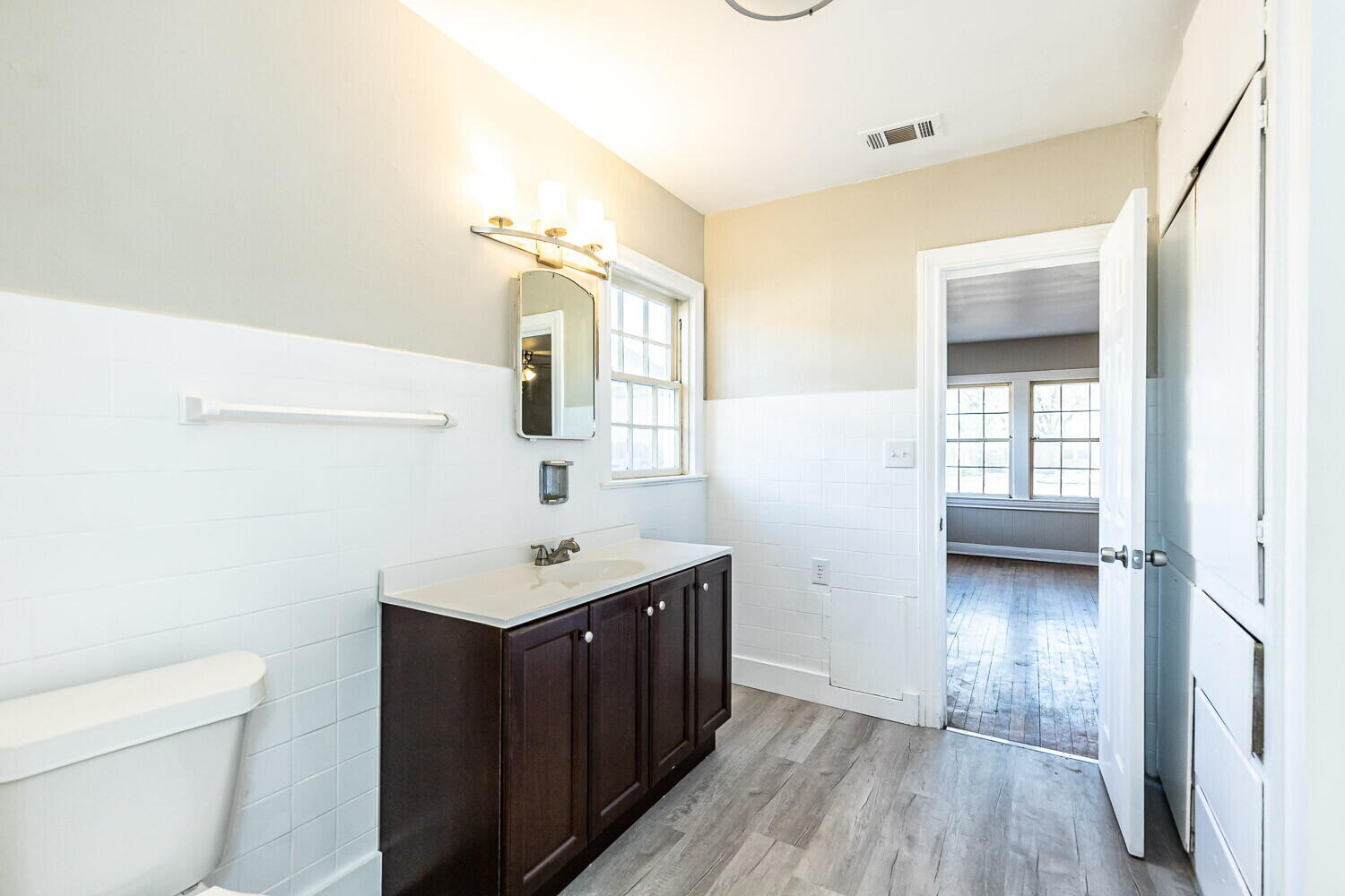 1914 25th Street Lubbock, TX 79411 - Photo 41 of 48 a bathroom with a sink a toilet and a mirror