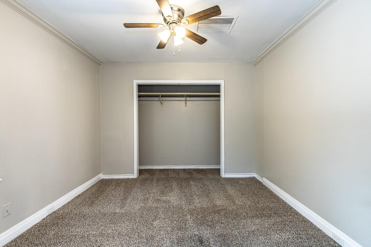 1914 25th Street Lubbock, TX 79411 - Photo 46 of 48 an empty room with closet and a chandelier fan