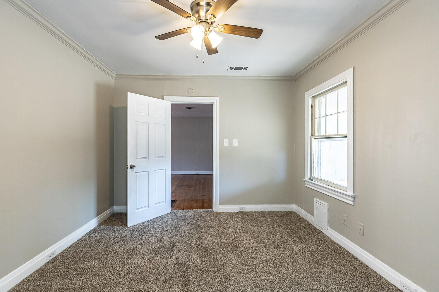 1914 25th Street Lubbock, TX 79411 - Photo 48 of 48 an empty room with windows and chandelier fan