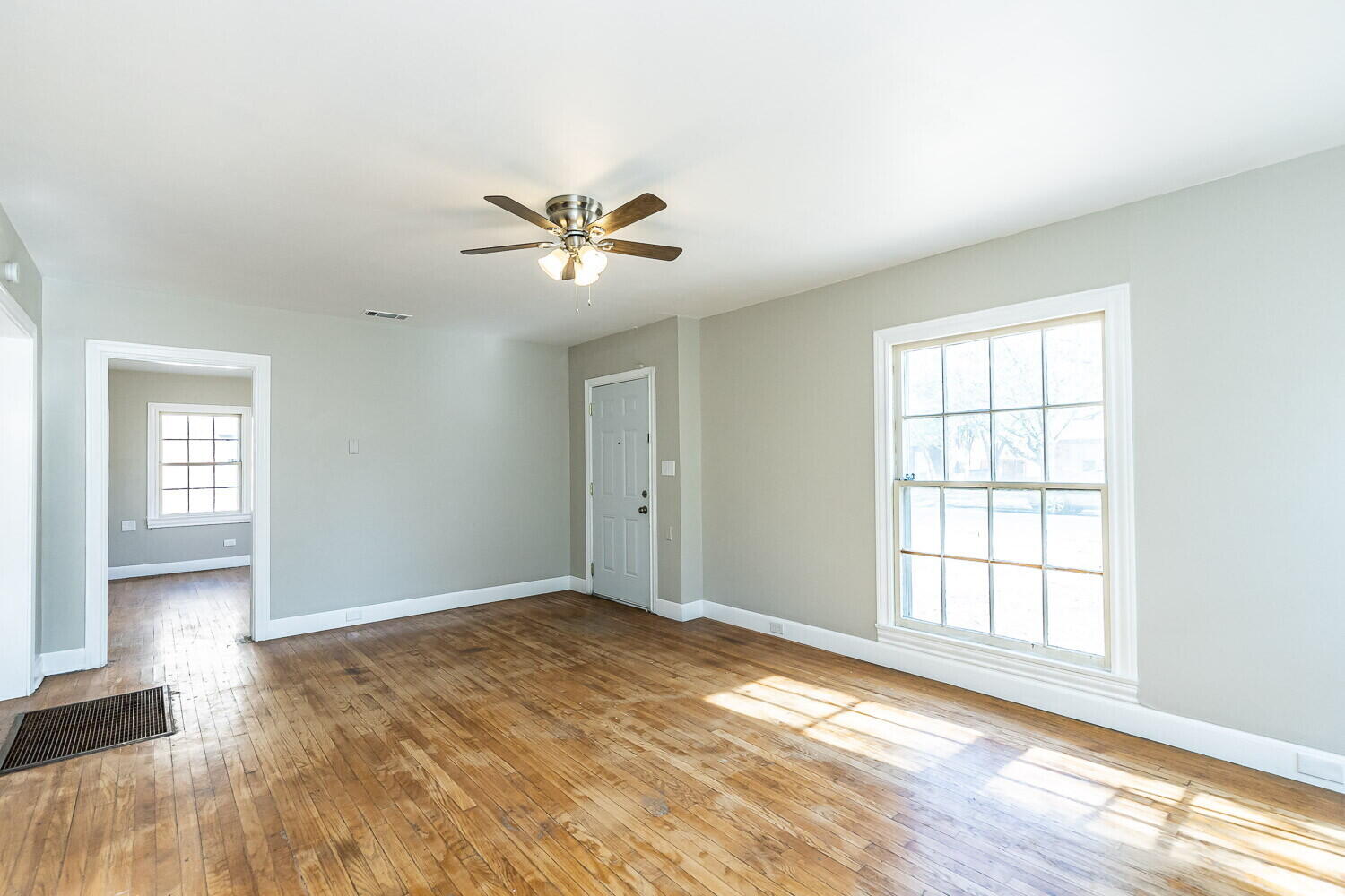 1914 25th Street Lubbock, TX 79411 - Photo 10 of 48 a view of an empty room with a window and wooden floor
