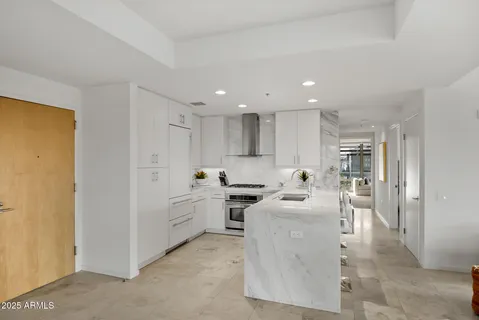 a kitchen with kitchen island a sink stainless steel appliances and cabinets