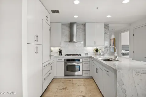 a kitchen with cabinets appliances and a sink