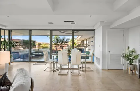 a living room with furniture and a floor to ceiling window