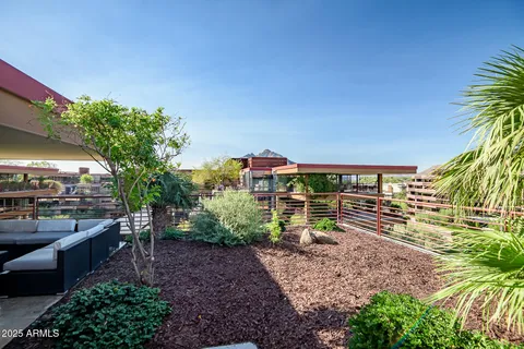a backyard of a house with outdoor seating and green space