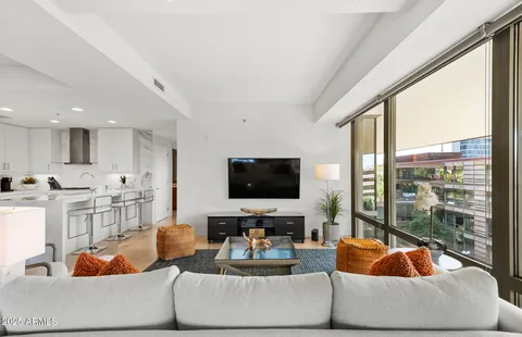 a kitchen with a dining table chairs cabinets and stainless steel appliances