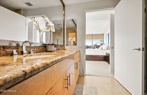 a bathroom with a double vanity sink mirror and toilet
