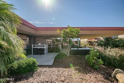 a view of roof deck with couches and potted plants