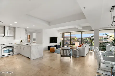 a kitchen with white cabinets appliances and sink